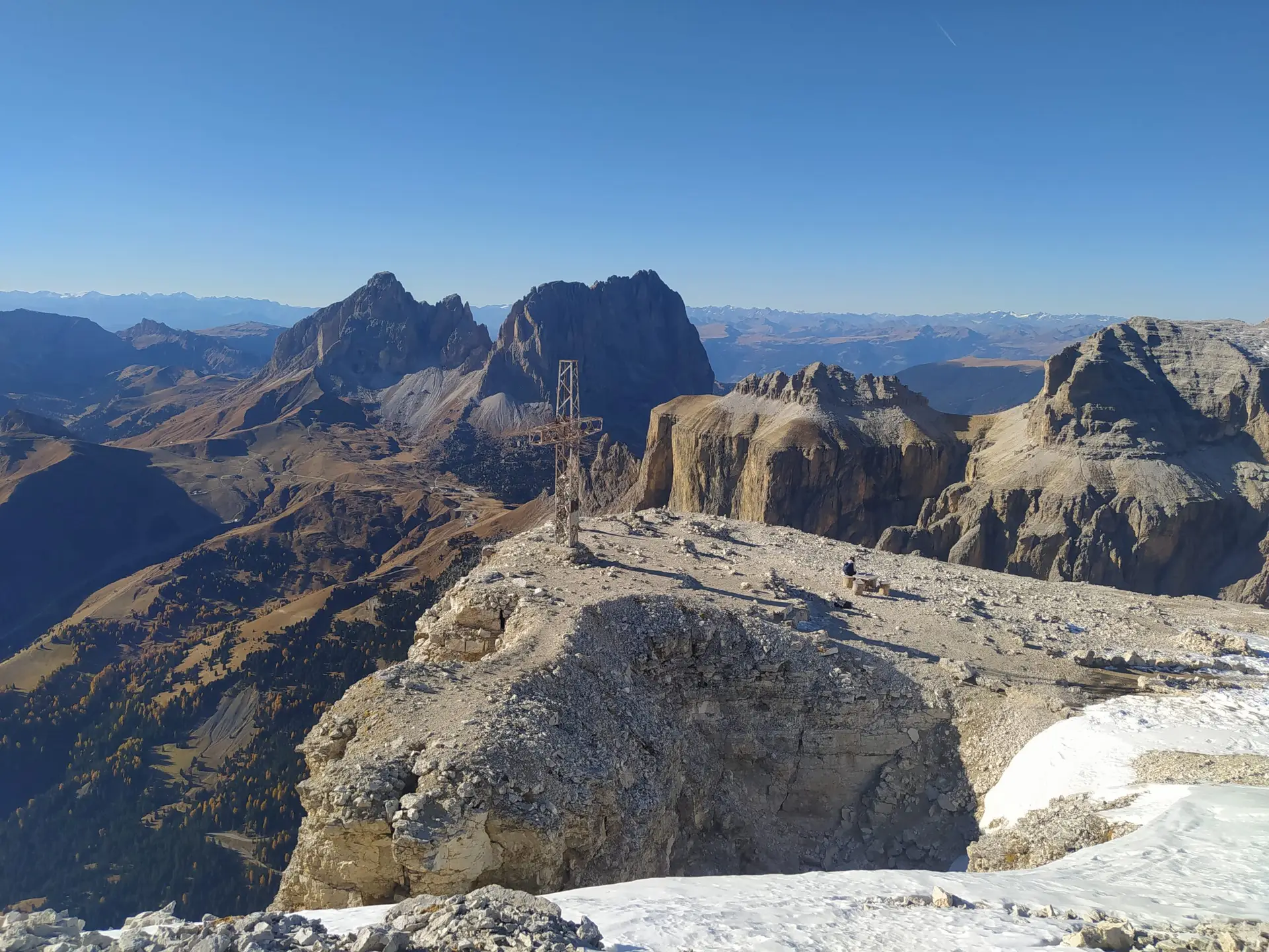 The cross at the summit of Sass Pordoi, Piz Ciavazes in the background. Stunning landscape of Dolomites in Italy.