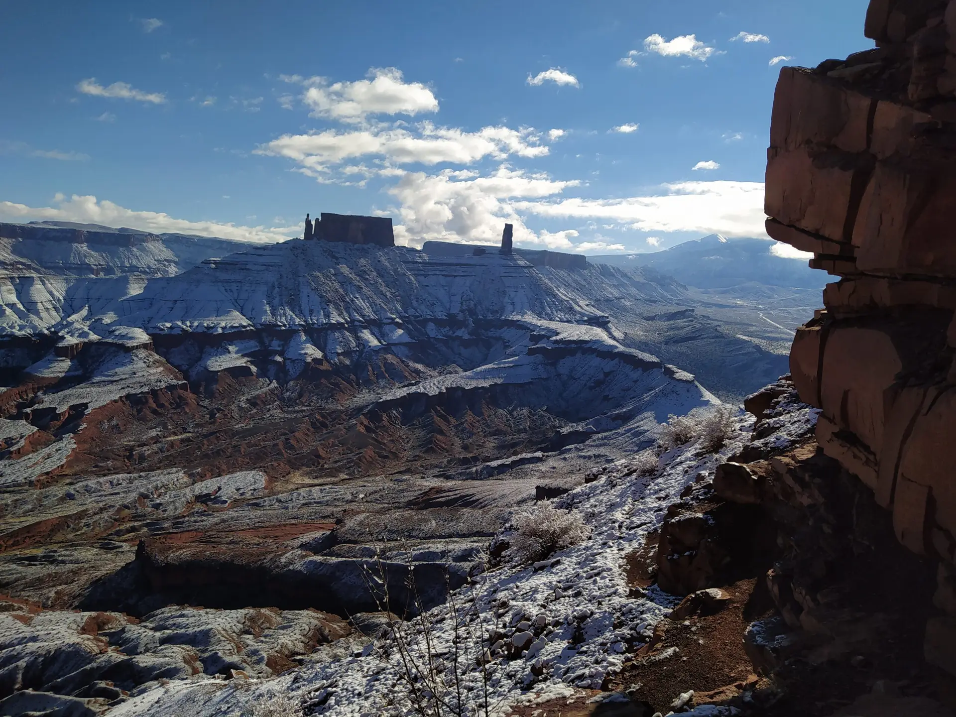 Stunning landscape of Utah covered in snow with Castleton Tower in the background.