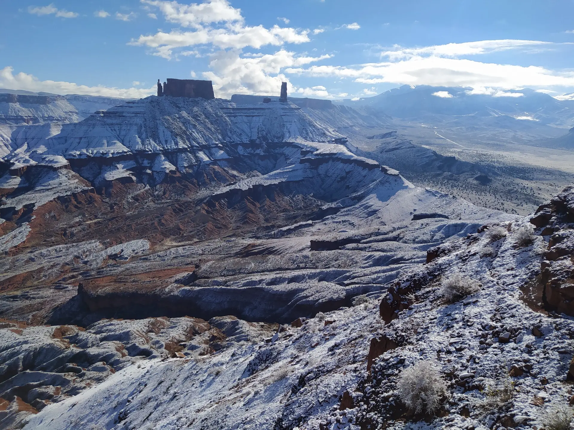 Fantastic view on a snowy desert with Castleton Tower in the background during a hike to a base jumping exit point.