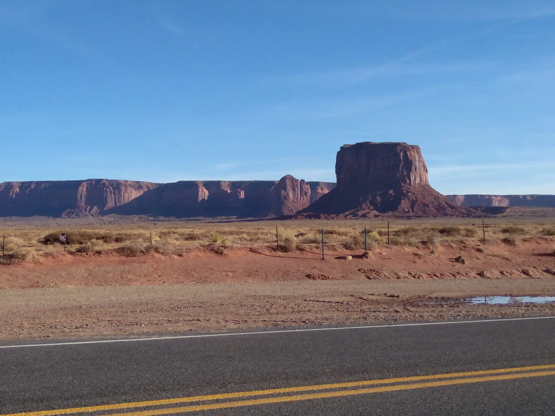 A geological shape called a mesa on a roadside of the western USA desert.