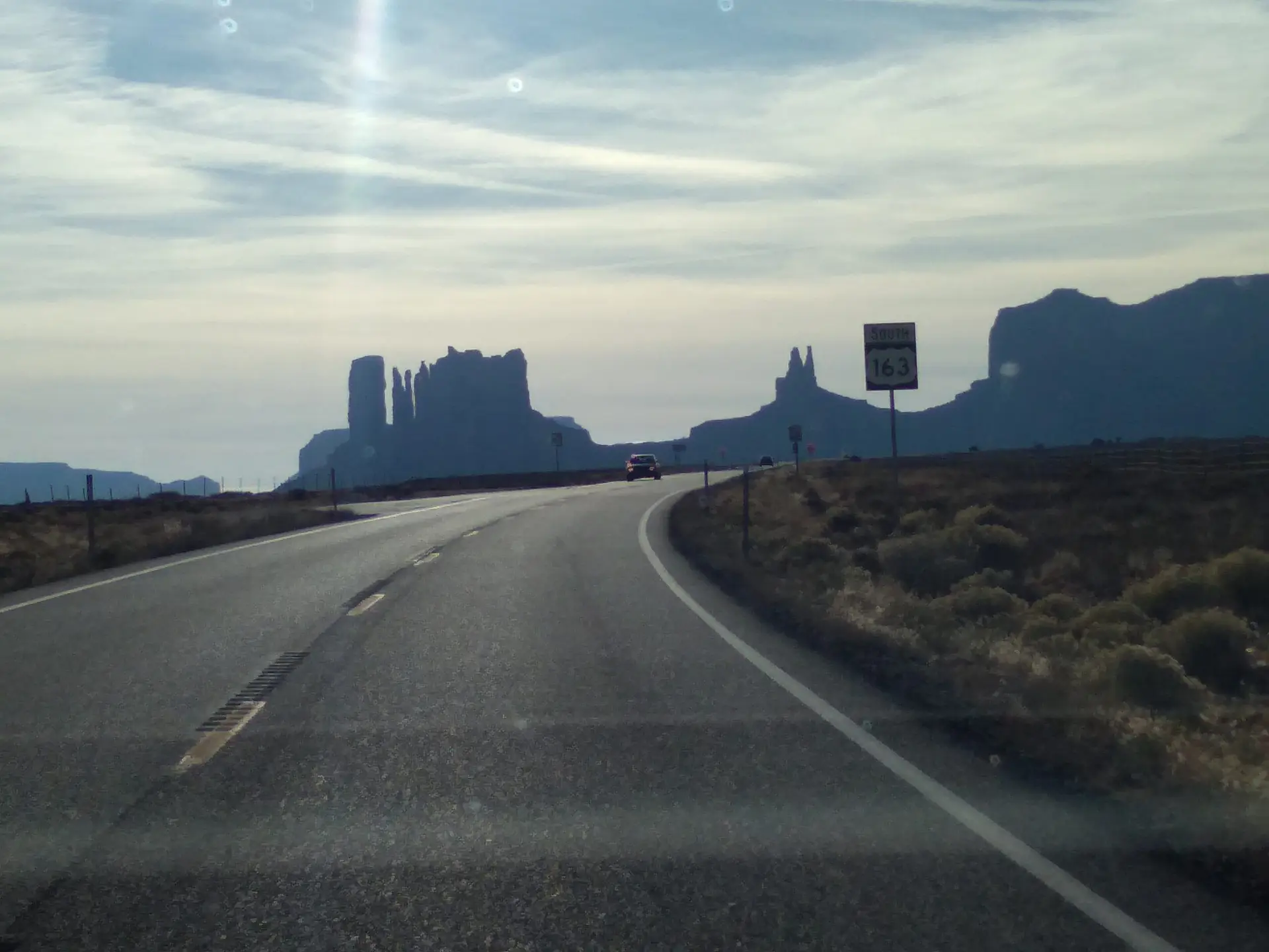 US 163 with the jutting cliffs of Monument Valley in the background in the western United States.