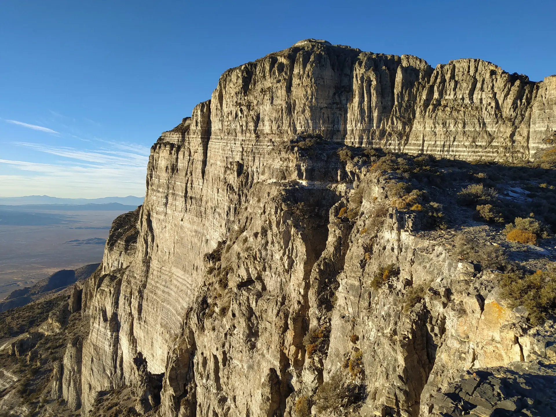 The setting sun lights up the southwest face of Notch Peak on the western edge of Utah in the desert.